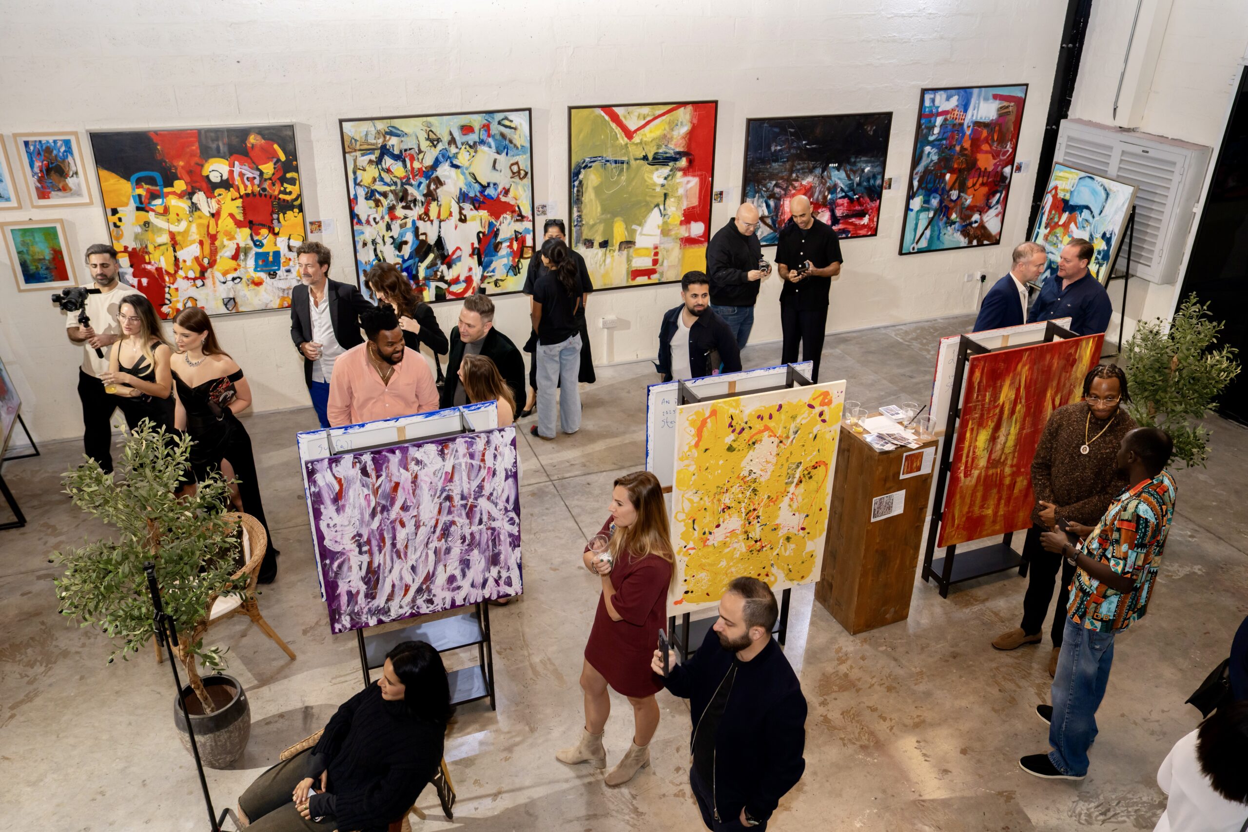Gallery interior with several Nupur Jha paintings on display