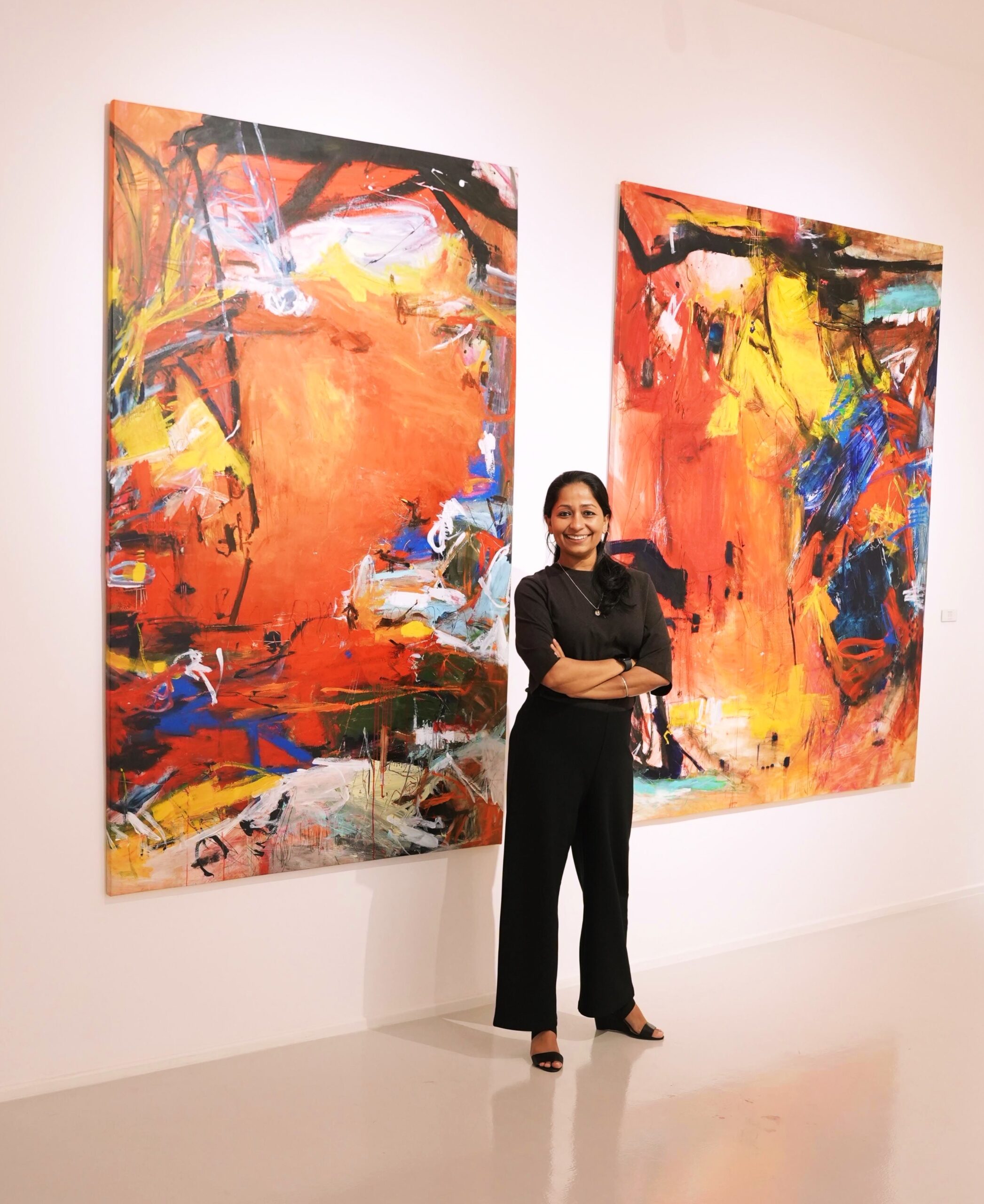 Two framed abstract paintings by Nupur Jha hung side by side
