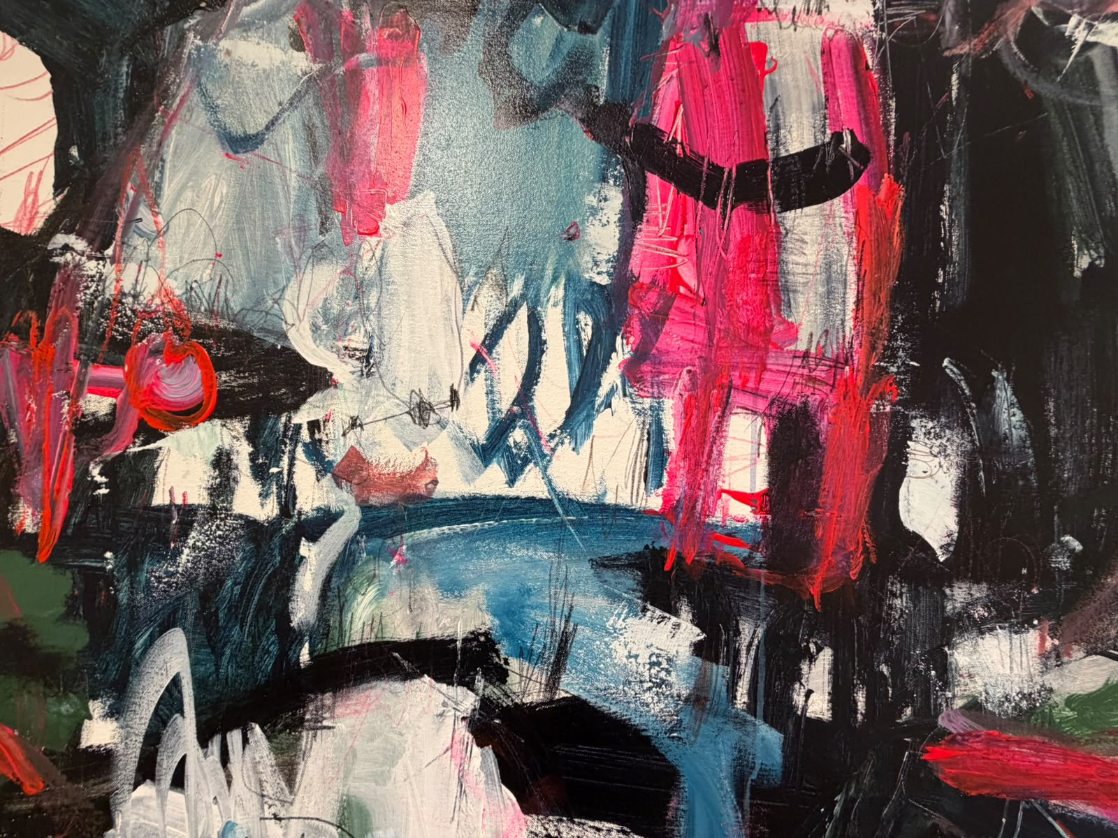 Artist's hand mixing paint on a palette